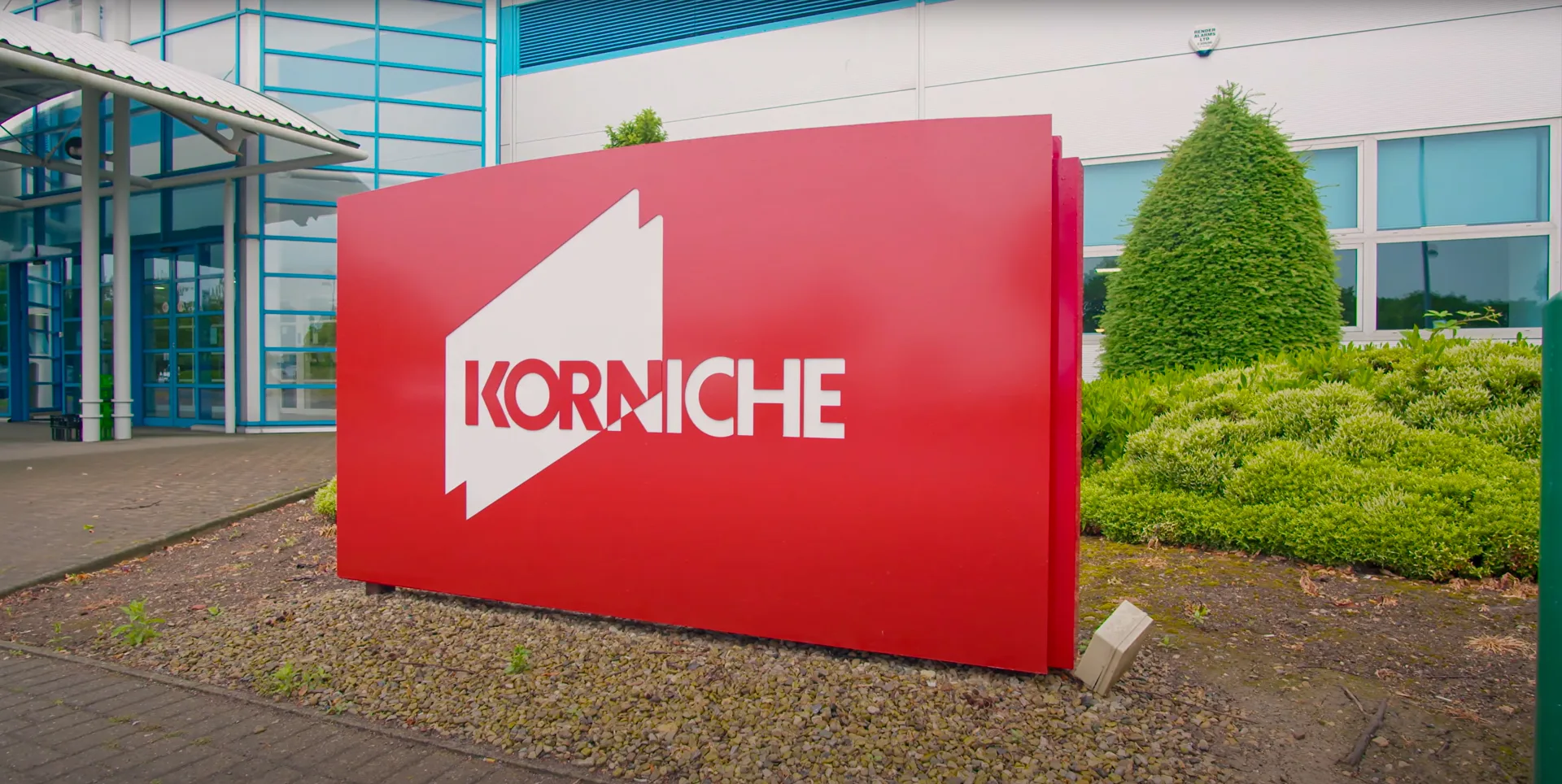 Made for Trade: Welcome to Our Home (Korniche Sign) Photo of the exterior of the Made for Trade factory and offices. The photo features a large red Korniche sign prominently displayed at the front of the building.
