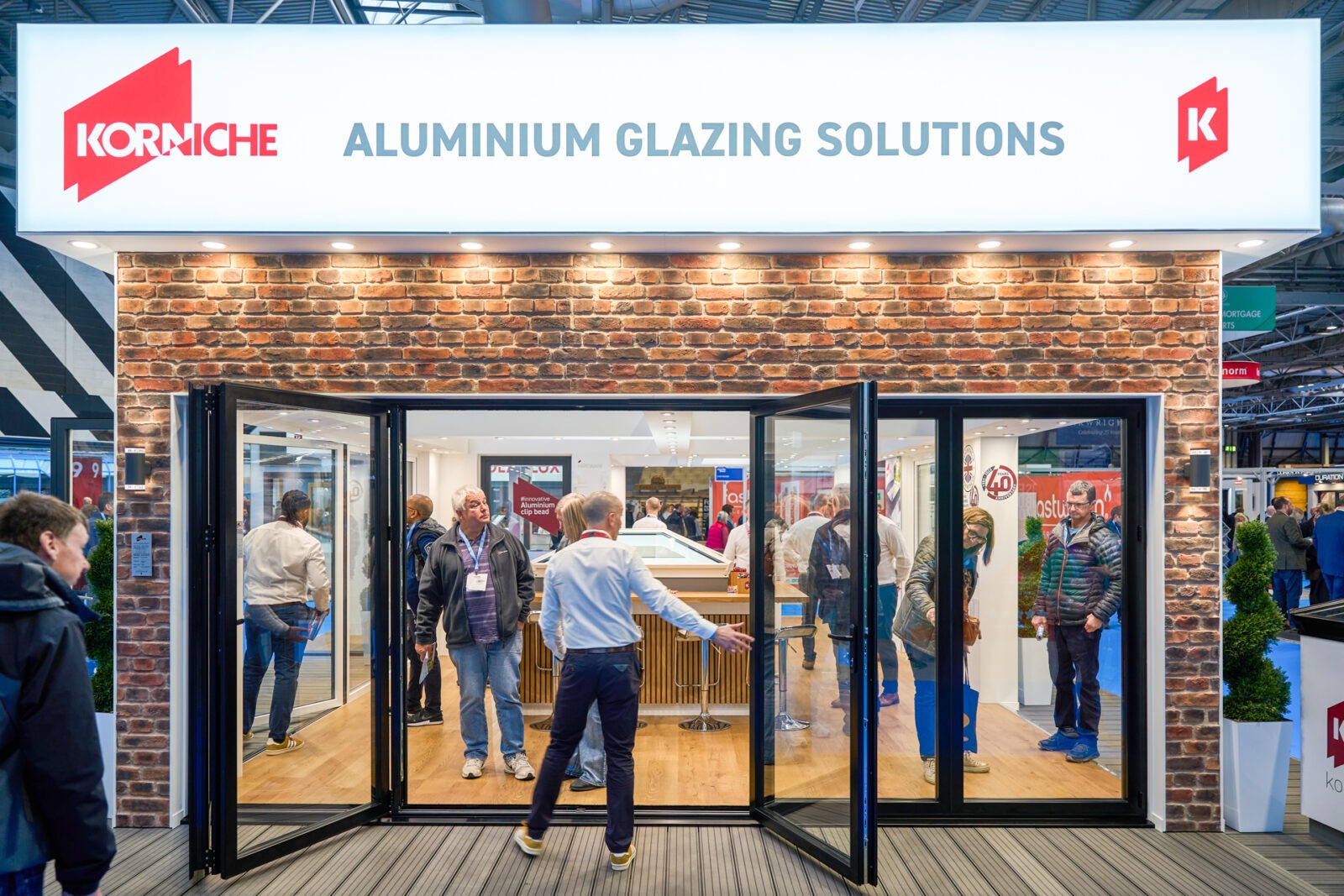 Korniche Homebuilding Show Stand Korniche Stand at Homebuilding Show - Leigh Greenwood discusses Bi-fold Doors with customer.