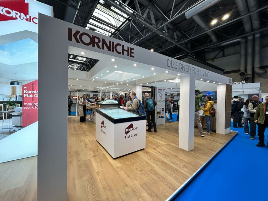 Korniche Stand B143, exterior view, with customers viewing the Korniche Flat Glass, Bifold door, and roof lantern.