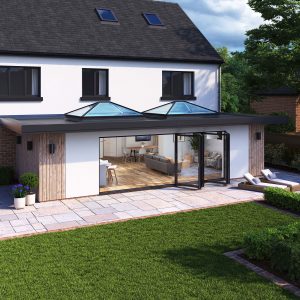 Open to the Outdoors: Korniche Bifold Door and Roof Lanterns Daytime exterior view of a home extension featuring two Korniche Roof Lanterns and a fully open Korniche Bifold Door leading to a patio and garden.