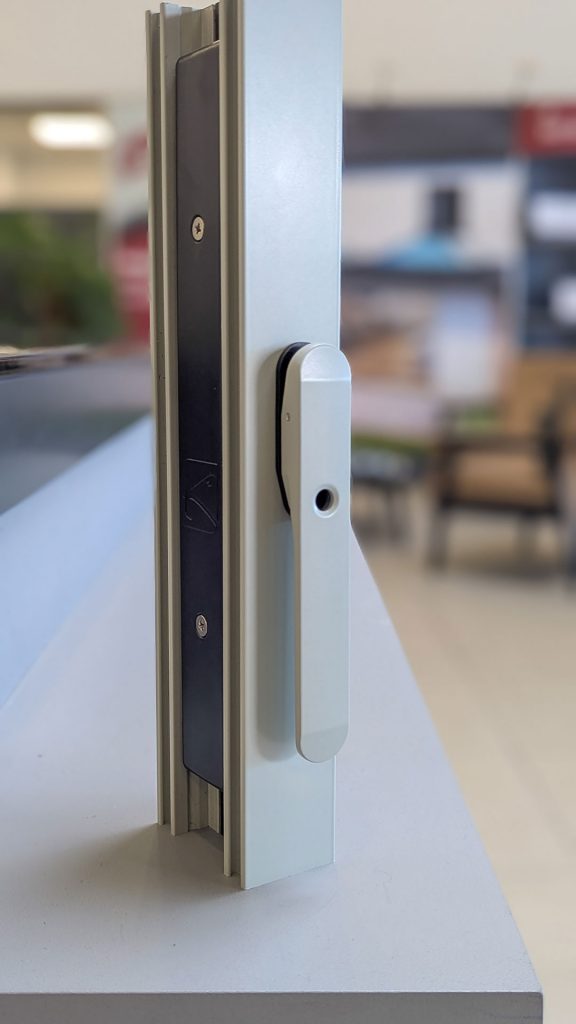 Close-up, portrait view of the new Agate Grey shootbolt handle on a Korniche Bifold Door, highlighting its modern aesthetic and perfect colour match with the door's agate grey profile.
