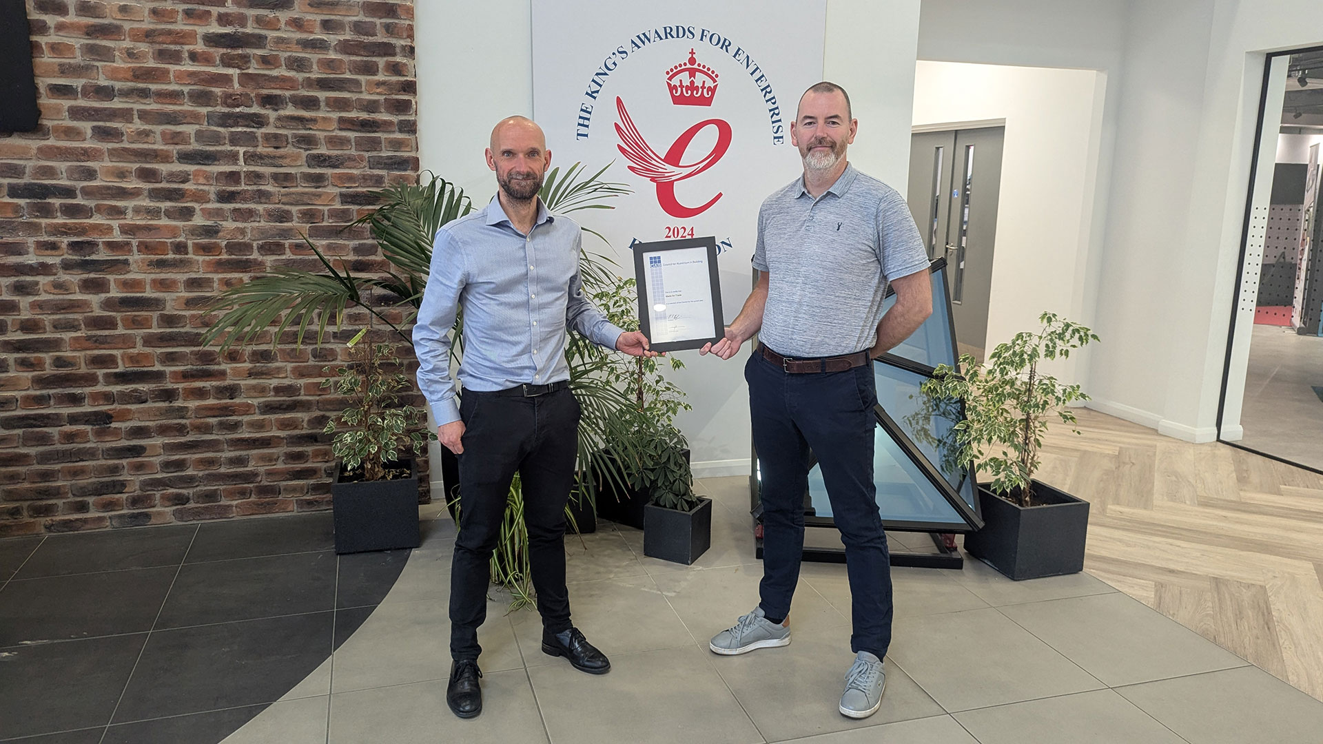 Chris Wann (Commercial Director) and Gavin Herdman (Head of Engineering) holding the CAB (Council For Aluminium In Building) certificate in the Made For Trade reception.