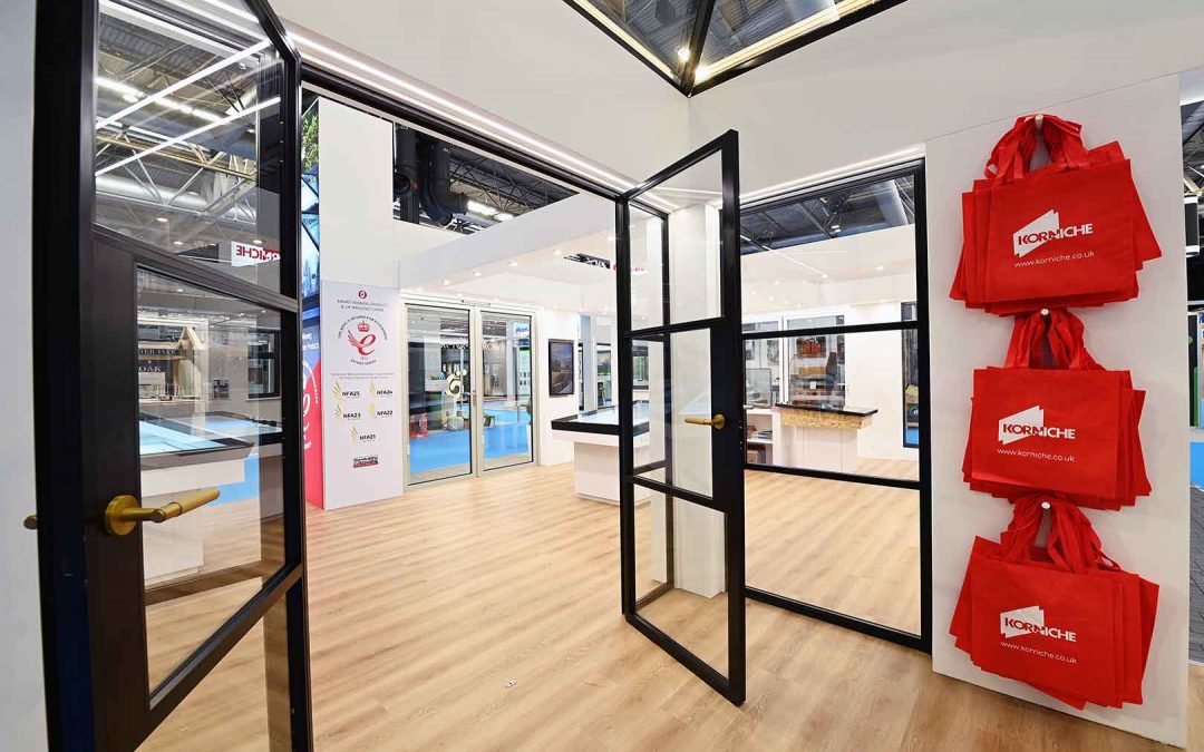 Korniche stand at Homebuilding and Renovating Show featuring internal glass partitions and aluminium glazing systems