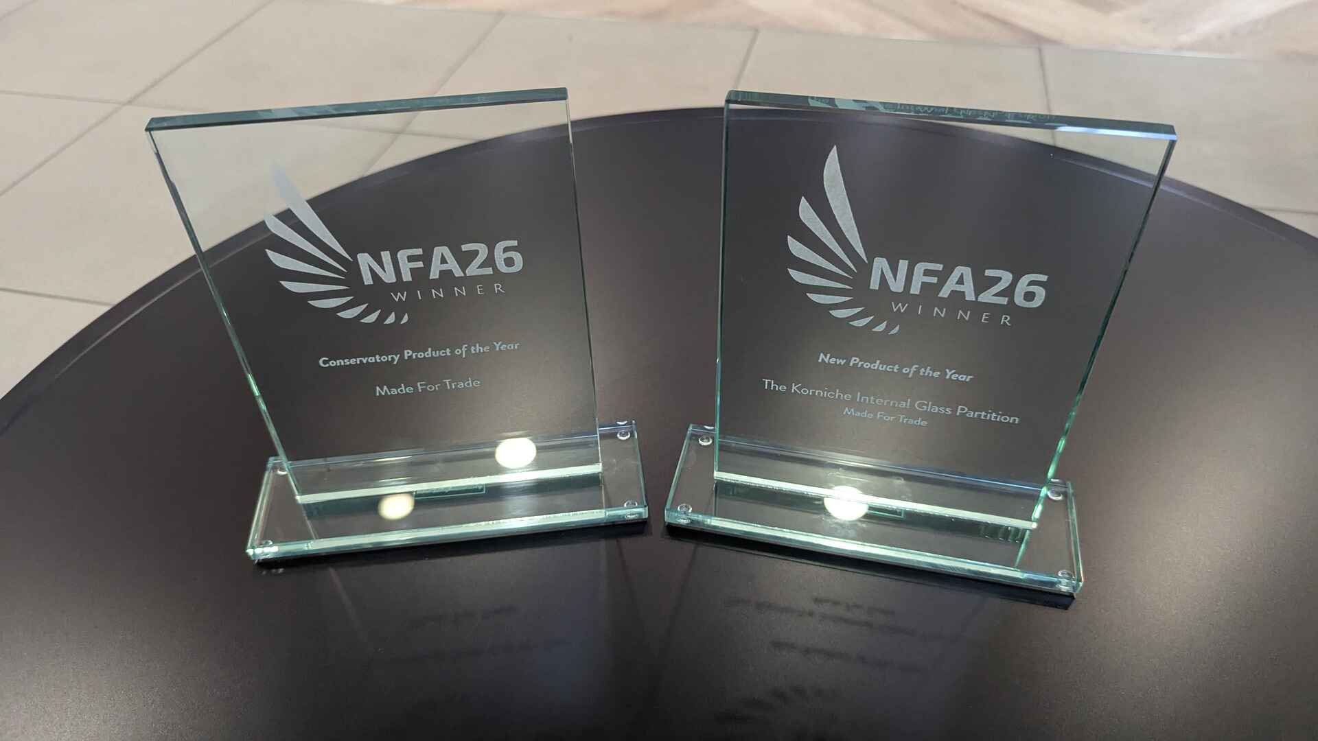 Made For Trade Wins Two NFA 2026 Industry Awards Close-up of Made For Trade's two NFA 2026 trophies for Conservatory Product of the Year and Korniche Internal Glass Partition New Product of the Year.