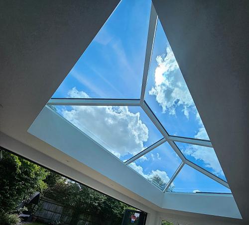 Korniche Roof Lantern showcasing bright blue sky and clouds.